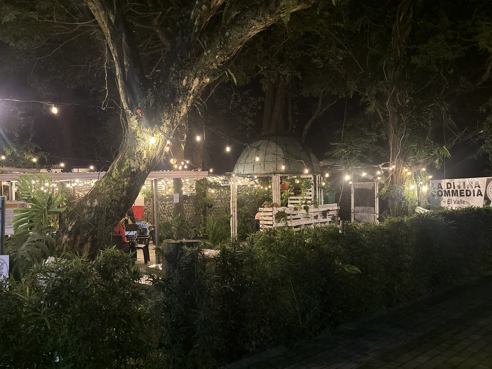 Foto real del jardín con luces cálidas de La Divina Commedia El Valle